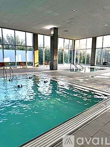 A large indoor swimming pool with people in it.