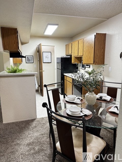 A kitchen with a dining table set for two.