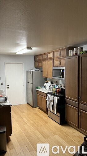 A kitchen with wooden cabinets and a black countertop.
