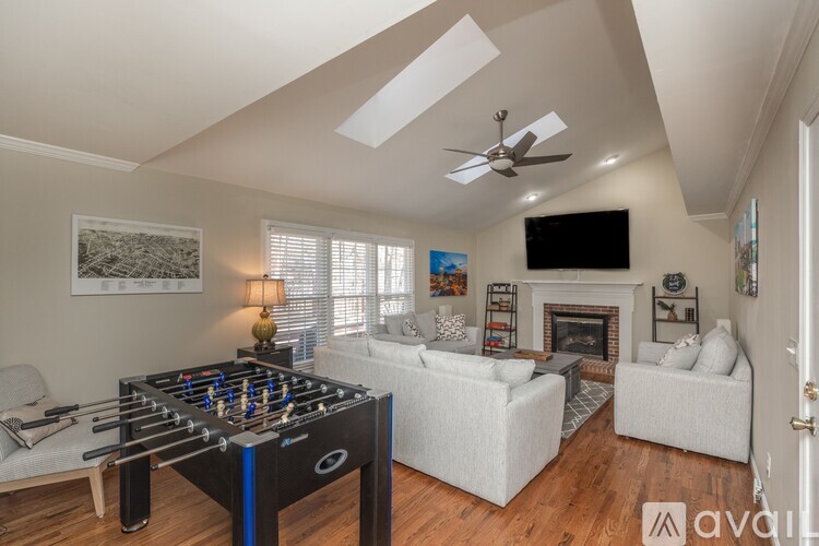 A living room with a foosball table in the middle.