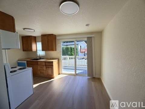 A kitchen with wooden cabinets and a white refrigerator.