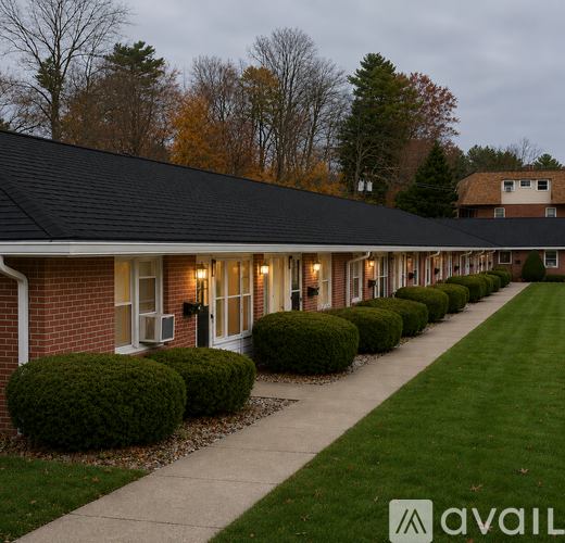 A long building with a row of bushes in front.