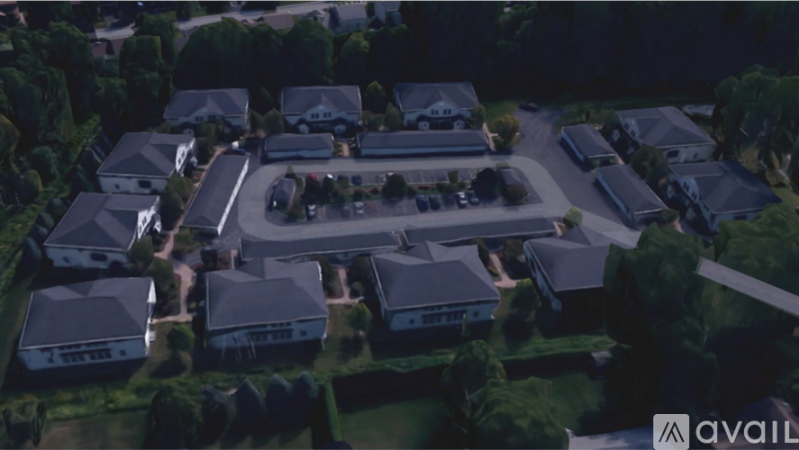 A bird's eye view of a residential area with houses and a parking lot.