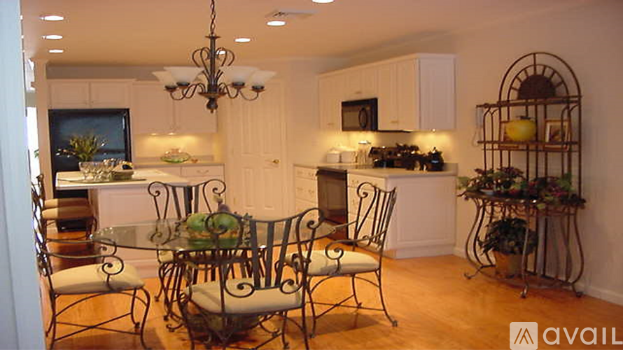 A dining room with a glass table and chairs.