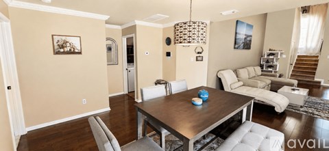 A dining room with a wooden table and chairs.