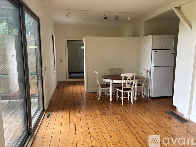 A kitchen area with a table and chairs.