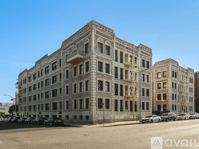 A large, old building with many windows is in the foreground.