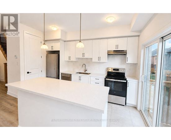 A white kitchen with a large island in the middle.