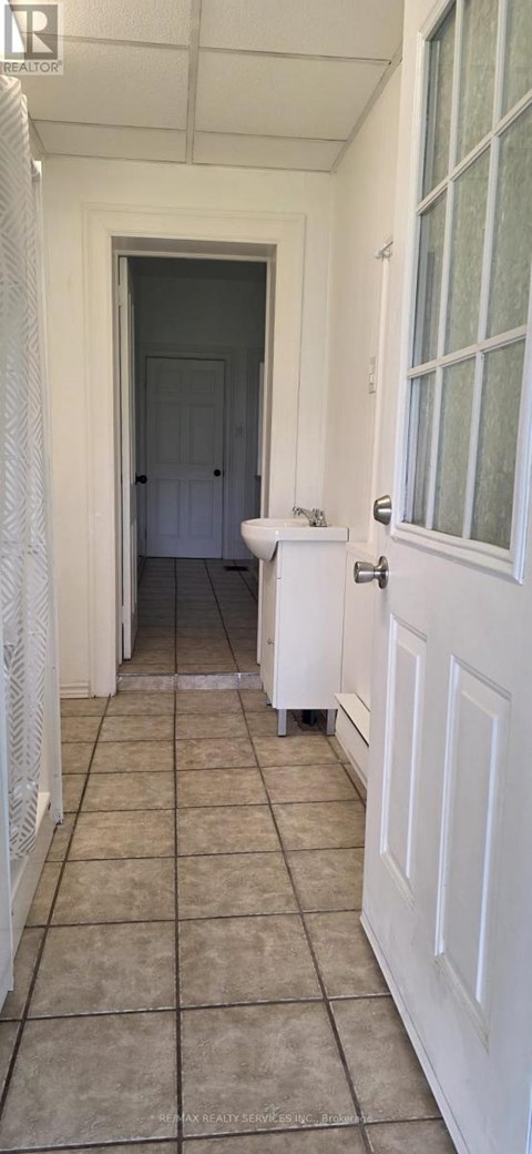 A white door is open to a dark hallway.
