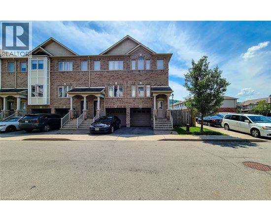 A large two-story house with a garage and a driveway in front.