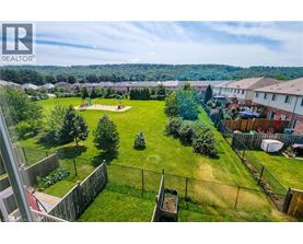 A view of a residential area with houses and a playground.