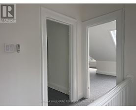 A white door with a mirror on the wall.