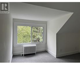 A room with a window and a radiator.