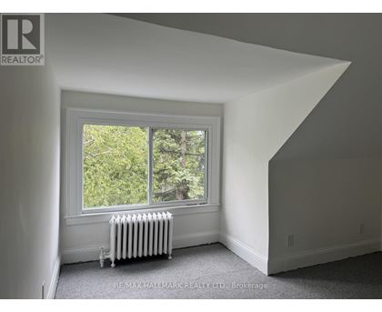 A room with a window and a radiator.