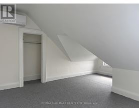 A room with a carpeted floor and a window.