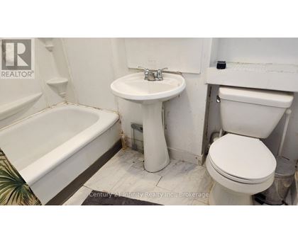 A white toilet sits next to a sink in a bathroom.