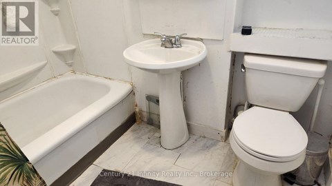 A white toilet sits next to a sink in a bathroom.