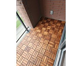 A tile floor with a brick wall and a window.