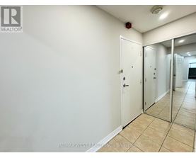A white door with a mirror on the wall.