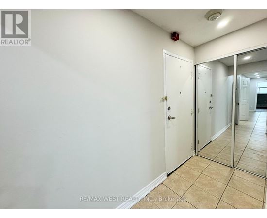 A white door with a mirror on the wall.