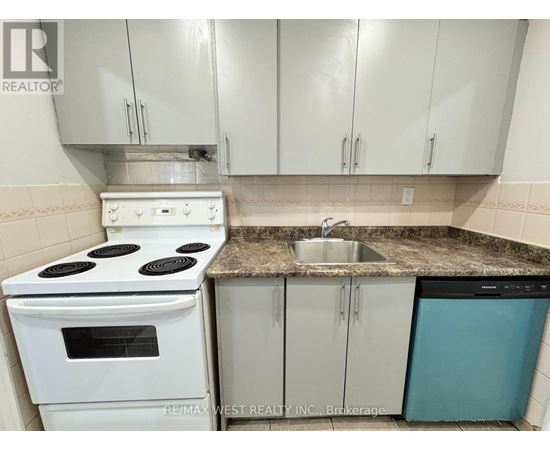 A white stove and oven in a kitchen with white cabinets and a granite counter.