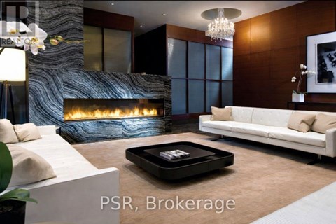 A modern living room with a fireplace and a white couch.