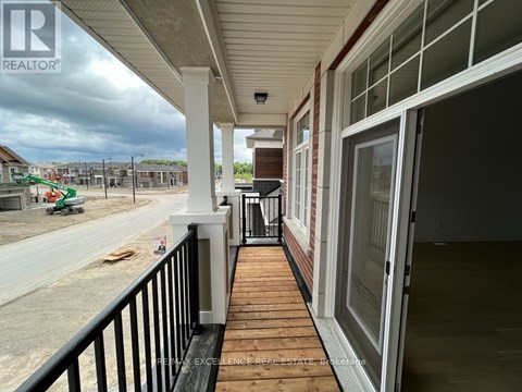 A balcony of a house under construction with a REALTOR sign.