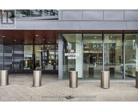 A building with a glass entrance and a sign that says "20 BUYERS NEWS".