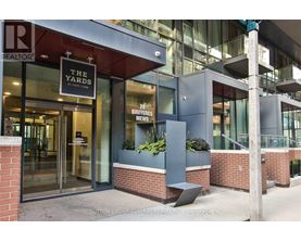 The front of a building with a glass door and a sign that says "The Yards".