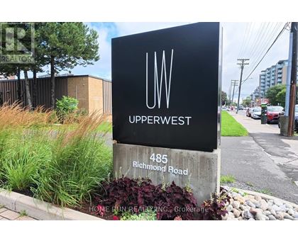 A sign for Upperwest stands in front of a building.