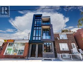 A modern building with a glass facade is the main focus of the image.