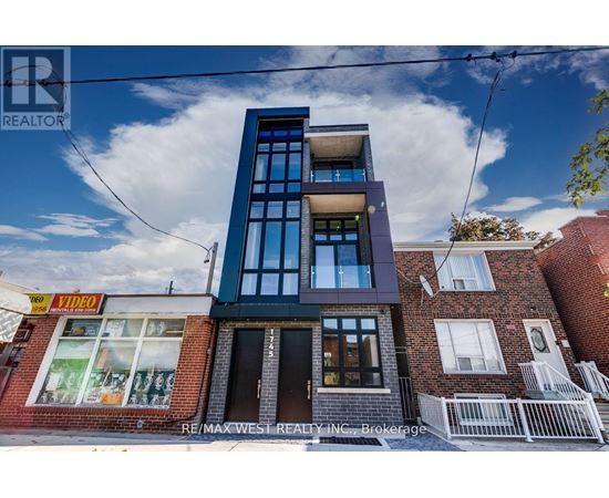 A modern building with a glass facade is the main focus of the image.
