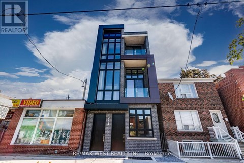 A modern building with a glass facade is the main focus of the image.