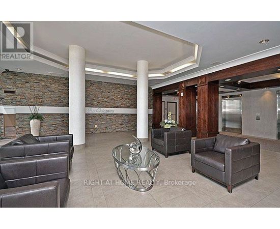 A living room with a stone wall and leather furniture.