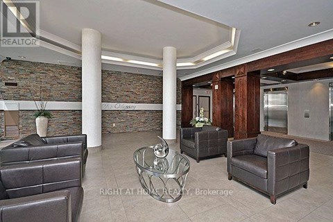 A living room with a stone wall and leather furniture.