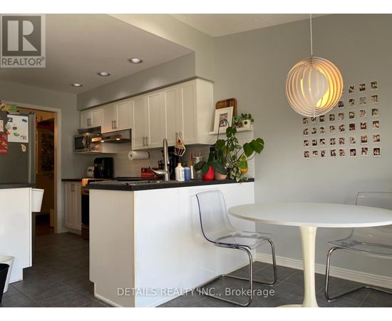 A modern kitchen with white cabinets and a large island.
