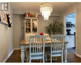 A dining room with a wooden table and chairs.