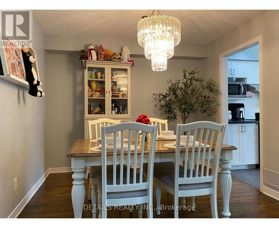 A dining room with a wooden table and chairs.