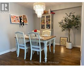 A dining room with a wooden table and chairs.