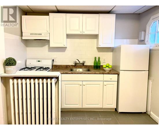 A kitchen with white cabinets and appliances.