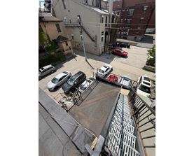 A parking lot with cars and a building in the background.