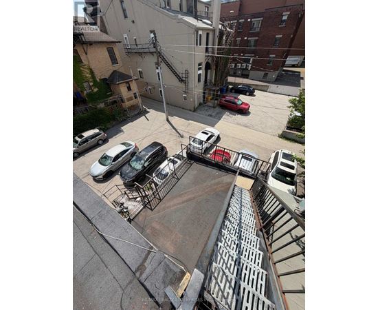 A parking lot with cars and a building in the background.