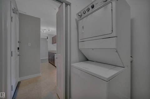 A white oven is in a kitchen with a white door.