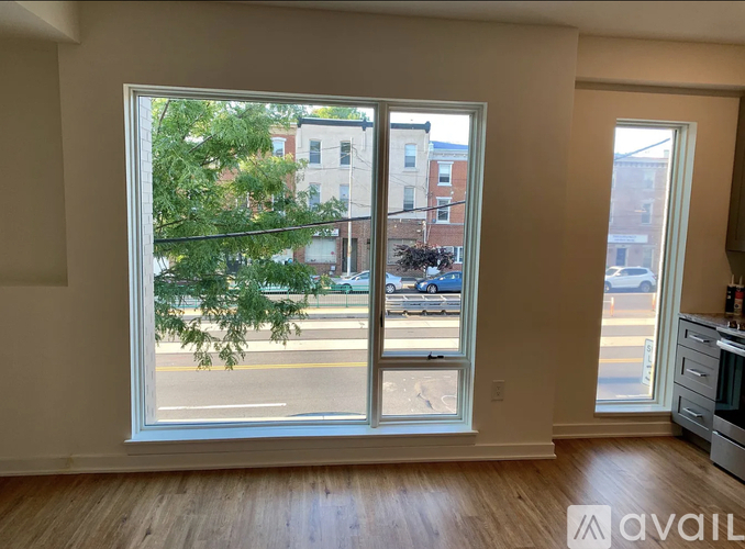 A room with a large window overlooking a street.