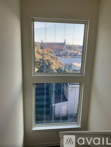 A window with a view of a residential area.
