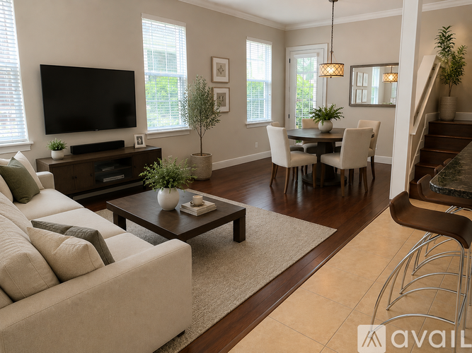 A living room with a white couch and a television.