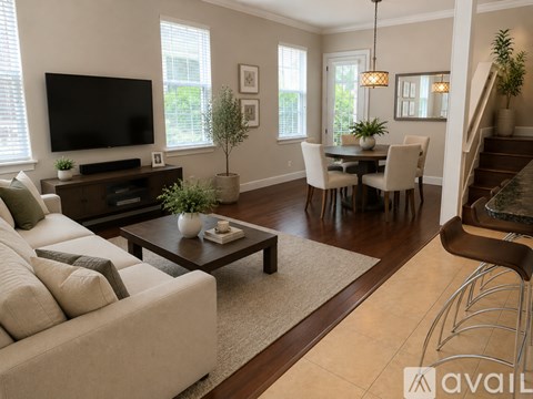 A living room with a white couch and a television.