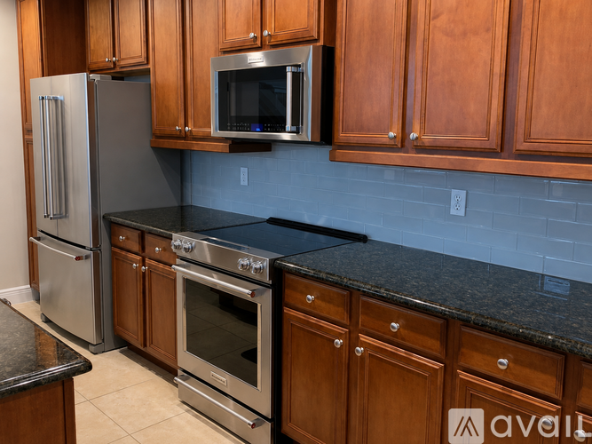 A kitchen with wooden cabinets and stainless steel appliances.