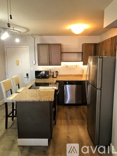 A kitchen with a granite countertop and stainless steel appliances.