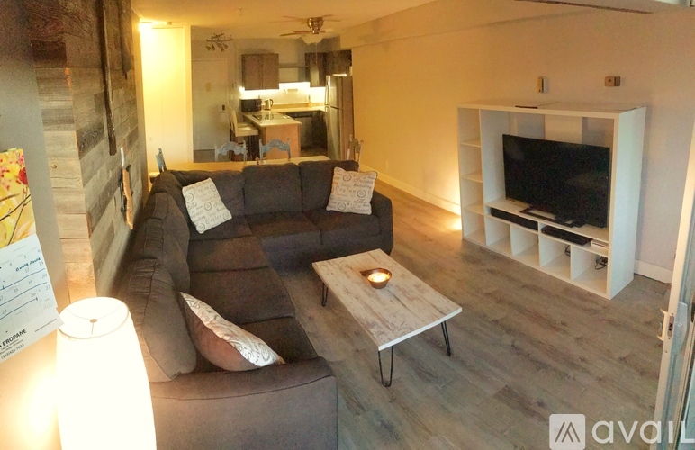 A living room with a couch, a coffee table, and a television.